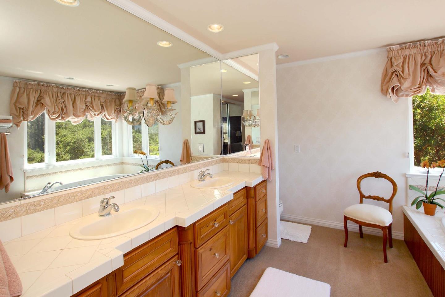 213 Gillette Road Watsonville, CA 95076 - Photo 10 of 27 a spacious bathroom with a sink and a large mirror