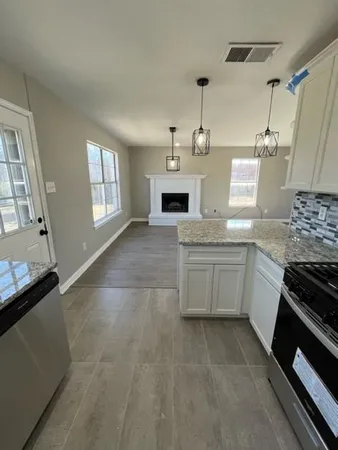 a large kitchen with a stove and a refrigerator