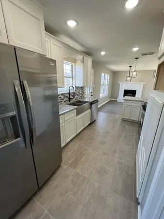 a kitchen with stainless steel appliances a refrigerator sink and stove