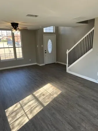 a view of an empty room and wooden floor