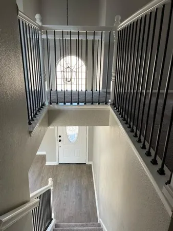a view of a room with wooden floor