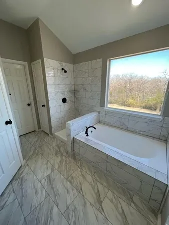 a bathroom with a bathtub and a shower