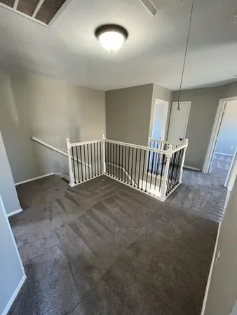 a view of staircase and utility room