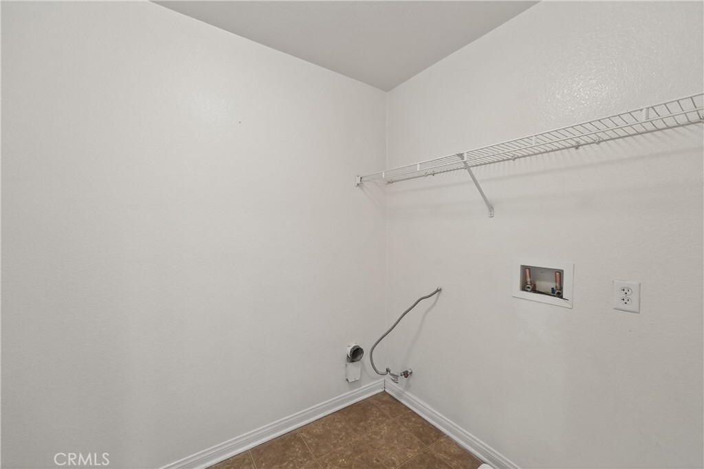 9406 Kentfield Court Riverside, CA 92508 - Photo 32 of 64 Spacious laundry room with hookups and shelving