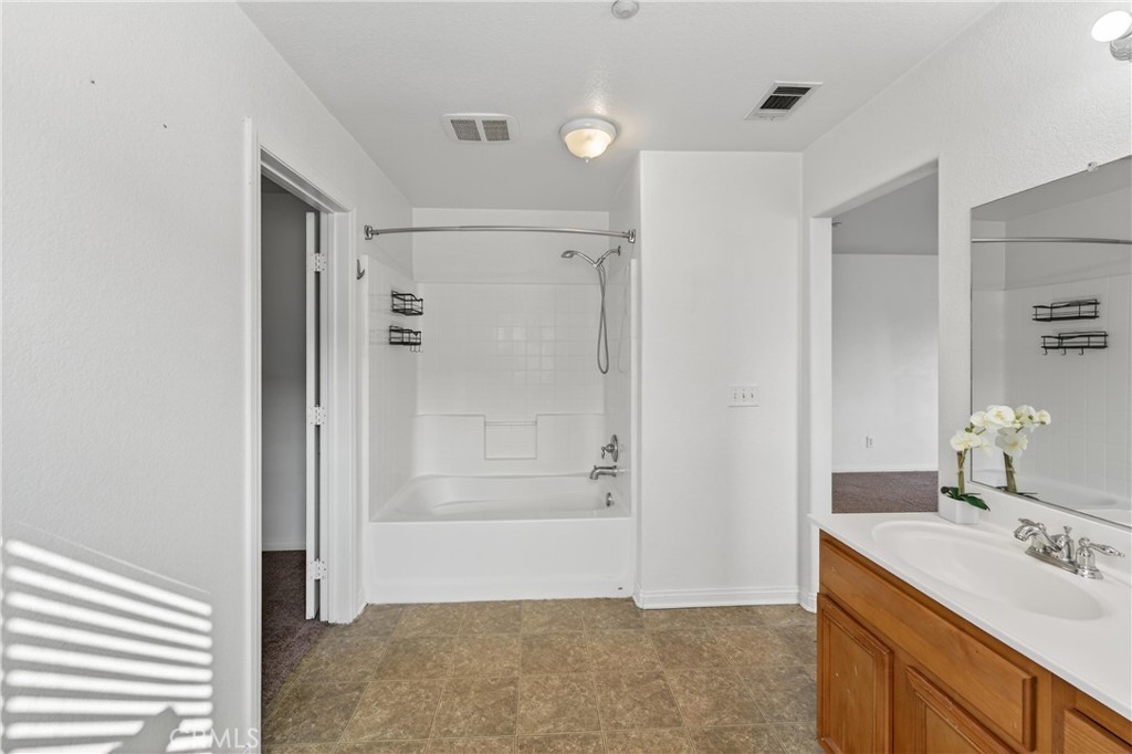 9406 Kentfield Court Riverside, CA 92508 - Photo 49 of 64 Primary bathroom includes dual sinks, soaking tub, and shower