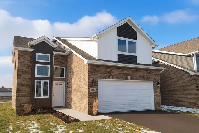 a front view of a house with a garage