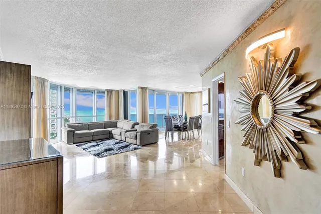 a living room with furniture and a floor to ceiling window