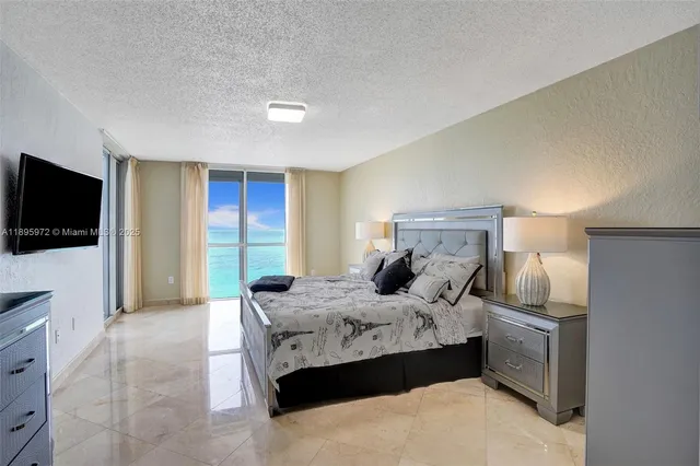 a bedroom with a bed and a flat screen television