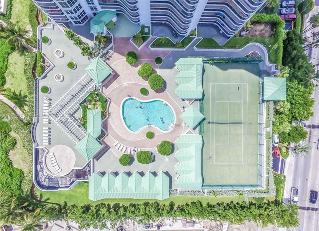 a view of a tall white building next to a road