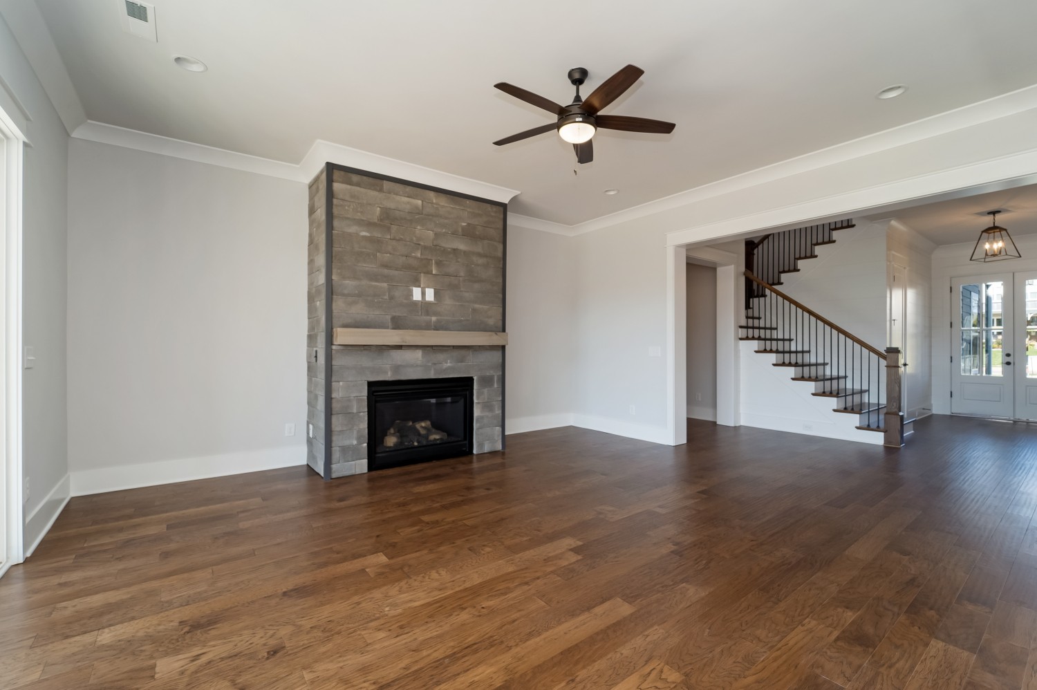 997 Spruce Ridge Lane Spring Hill, TN 37174 - Photo 8 of 30 a view of an empty room with wooden floor and a fireplace
