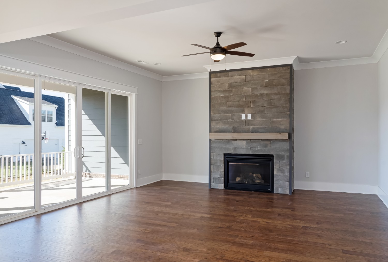 997 Spruce Ridge Lane Spring Hill, TN 37174 - Photo 10 of 30 a view of an empty room with wooden floor fireplace and a window