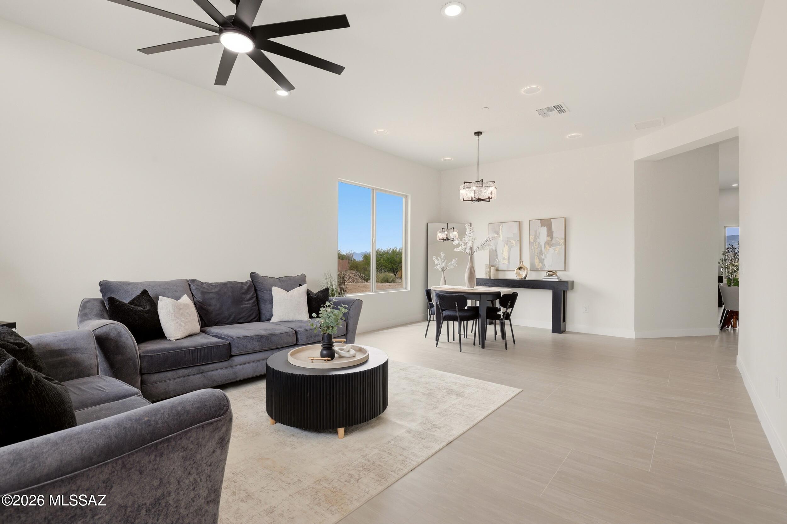 14527 East Sands Ranch Road Vail, AZ 85641 - Photo 15 of 48 a living room with furniture a clock and a chandelier