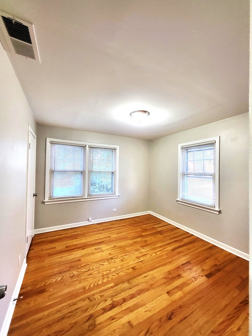 401 North Wolf Road Northlake, IL 60164 - Photo 5 of 15 a view of empty room with window and wooden floor