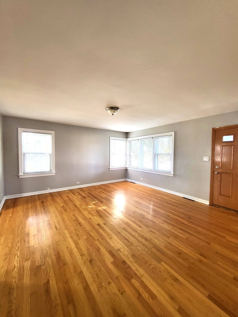 401 North Wolf Road Northlake, IL 60164 - Photo 7 of 15 a view of empty room with wooden floor and fan