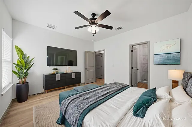 a bedroom with a bed and a flat screen tv