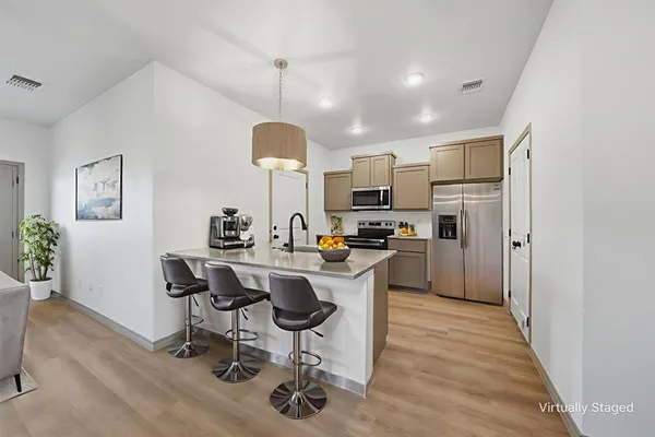 a kitchen with a sink a counter space appliances and cabinets