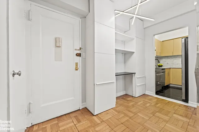 a view of a kitchen with a sink and a refrigerator