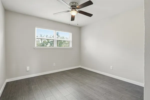 a bathroom with a granite countertop sink a toilet and bathtub