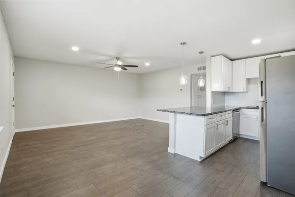a view of a kitchen with a sink and stainless steel appliances