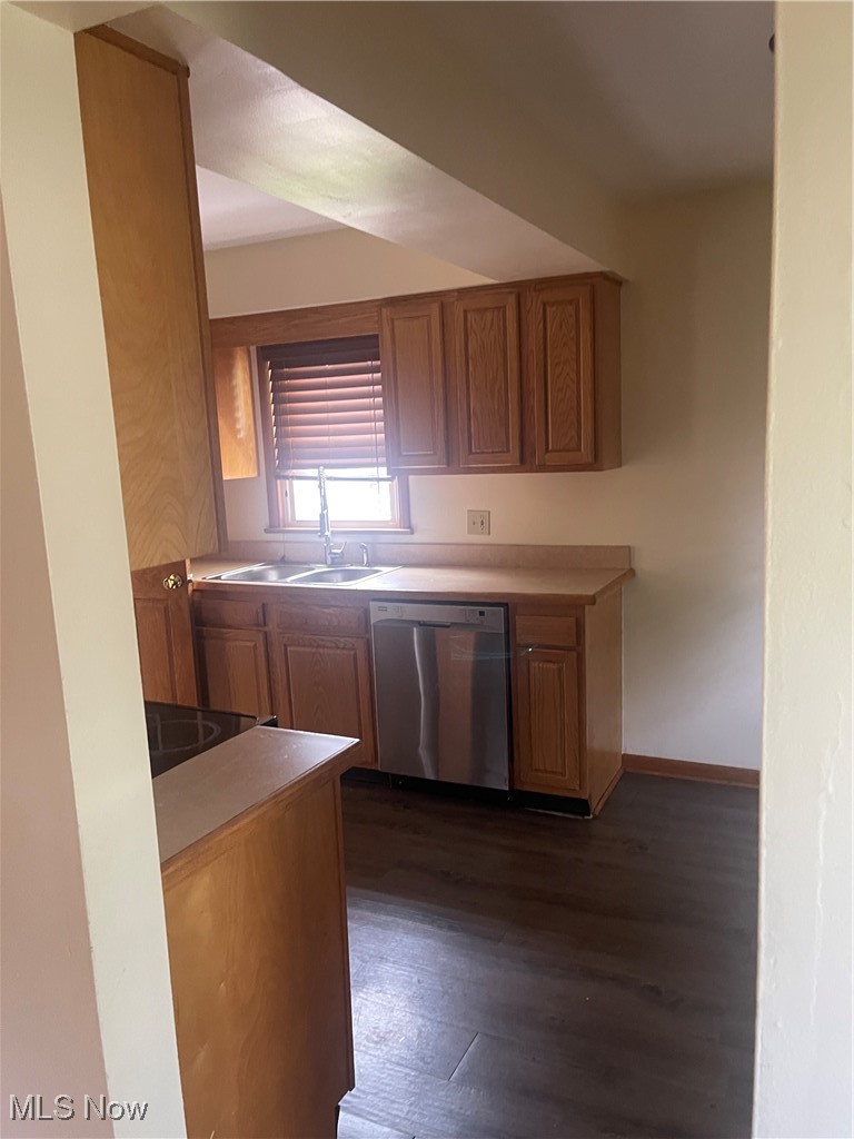1881 17th Street Southwest Akron, OH 44314 - Photo 17 of 20 Kitchen featuring dishwashing machine, dark wood-style floors, brown cabinetry, and light countertops