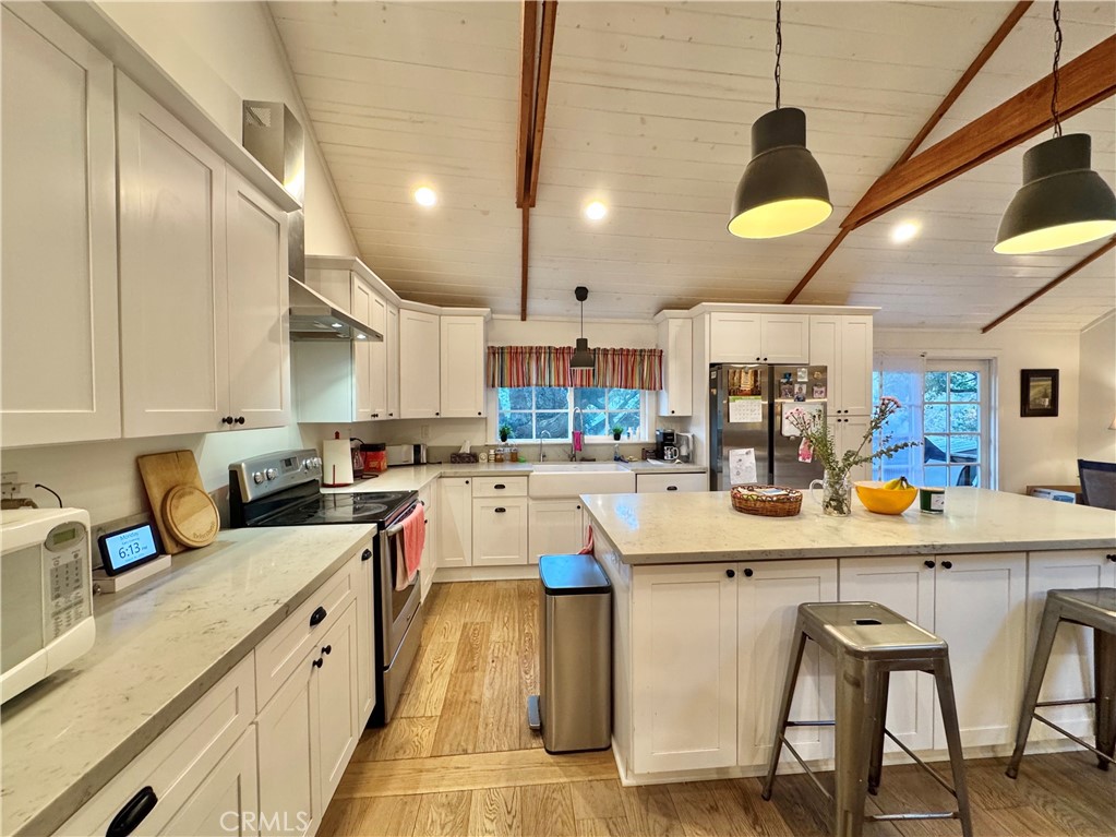 14941 Wildcat Canyon Road Silverado, CA 92676 - Photo 6 of 18 a kitchen with a sink a stove and chairs
