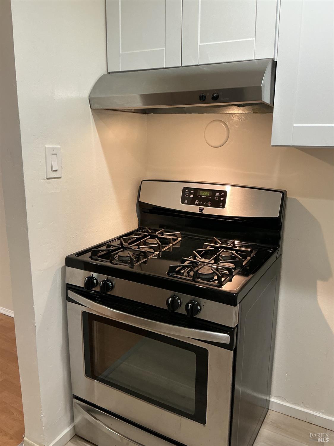 212 South E Street, Unit B Santa Rosa, CA 95404 - Photo 18 of 31 a stove top oven sitting inside of a kitchen