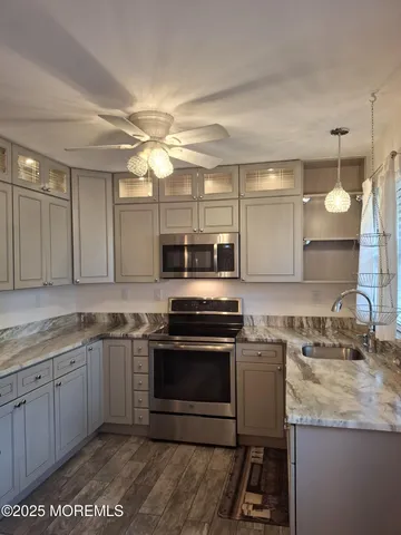 a kitchen with a stove a sink and a microwave