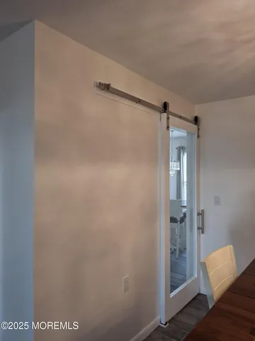 a spacious bedroom with a bed and mirror