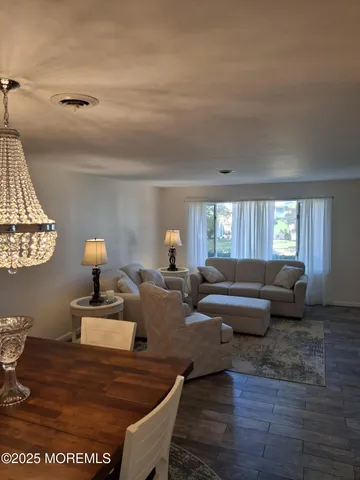 a living room with furniture and a dining table