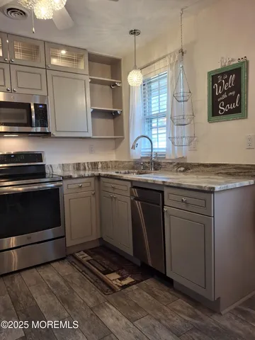 a kitchen with stainless steel appliances granite countertop a sink and cabinets