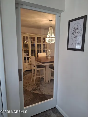 a view of a dining room with furniture and a window