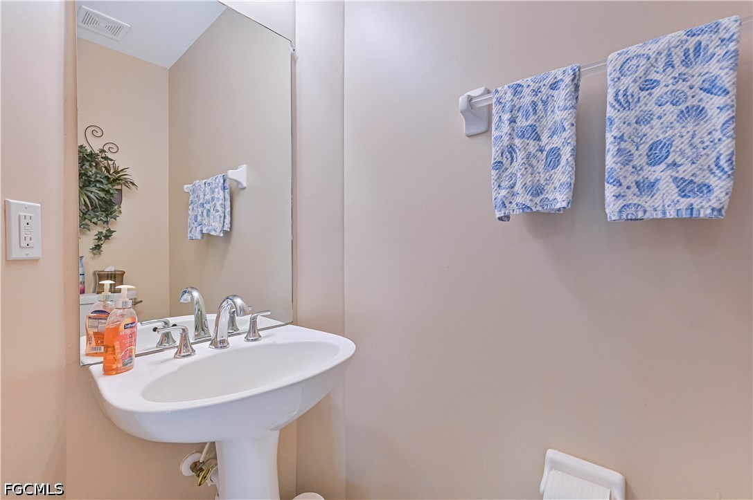 13120 Broadhurst Loop, Unit 505 Fort Myers, FL 33919 - Photo 17 of 28 a bathroom with a sink and a mirror