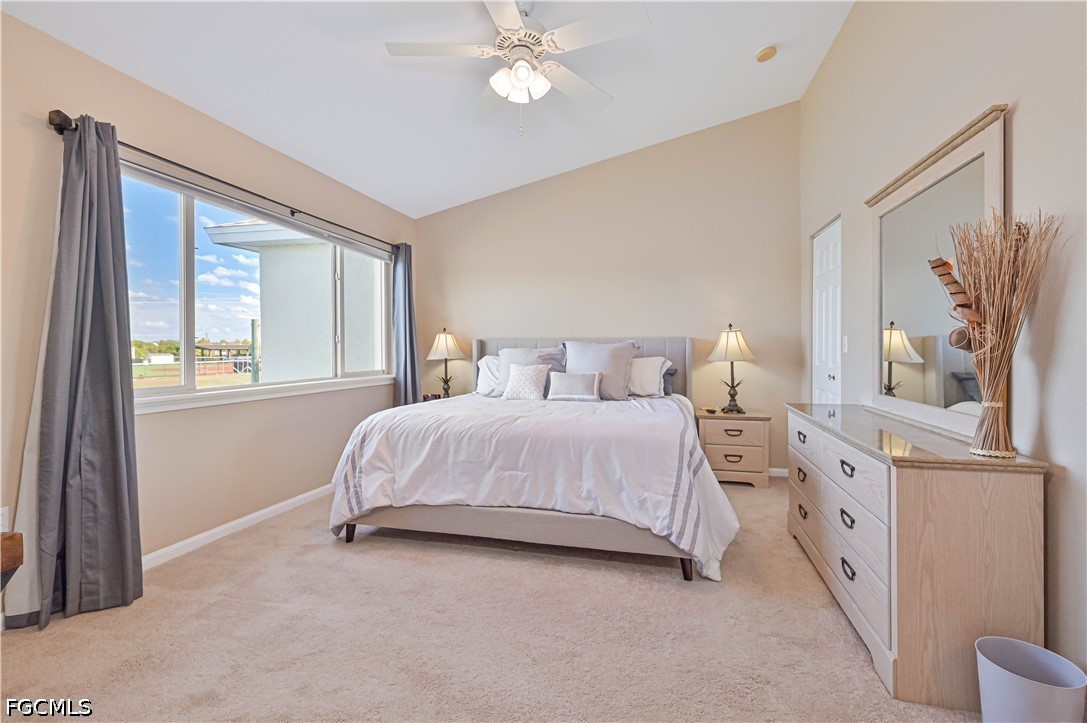 13120 Broadhurst Loop, Unit 505 Fort Myers, FL 33919 - Photo 18 of 28 a bedroom with a bed and a chandelier