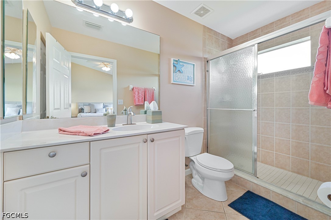 13120 Broadhurst Loop, Unit 505 Fort Myers, FL 33919 - Photo 21 of 28 a bathroom with a sink a toilet a mirror and shower