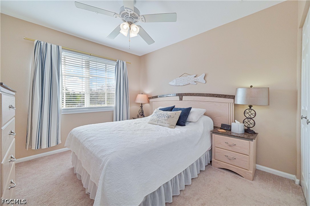 13120 Broadhurst Loop, Unit 505 Fort Myers, FL 33919 - Photo 22 of 28 a bedroom with a bed and a chandelier