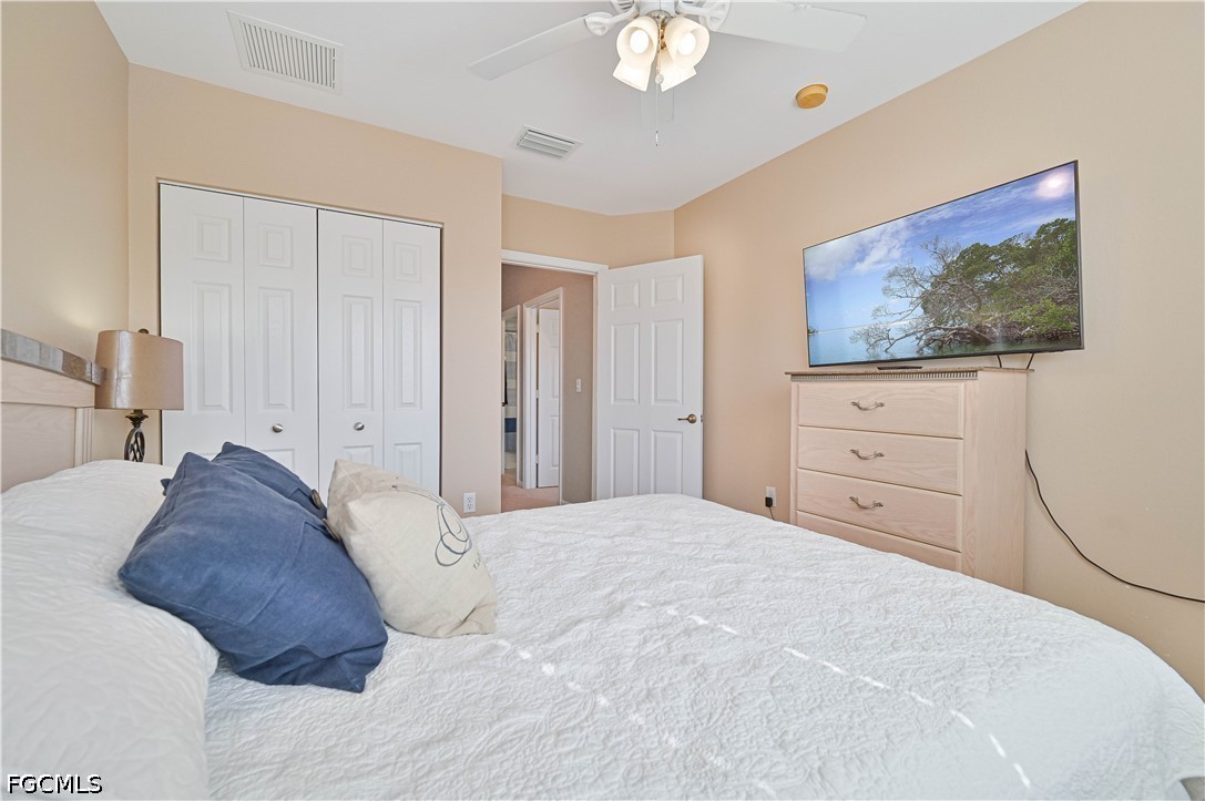 13120 Broadhurst Loop, Unit 505 Fort Myers, FL 33919 - Photo 23 of 28 a bedroom with a bed and a painting on the wall