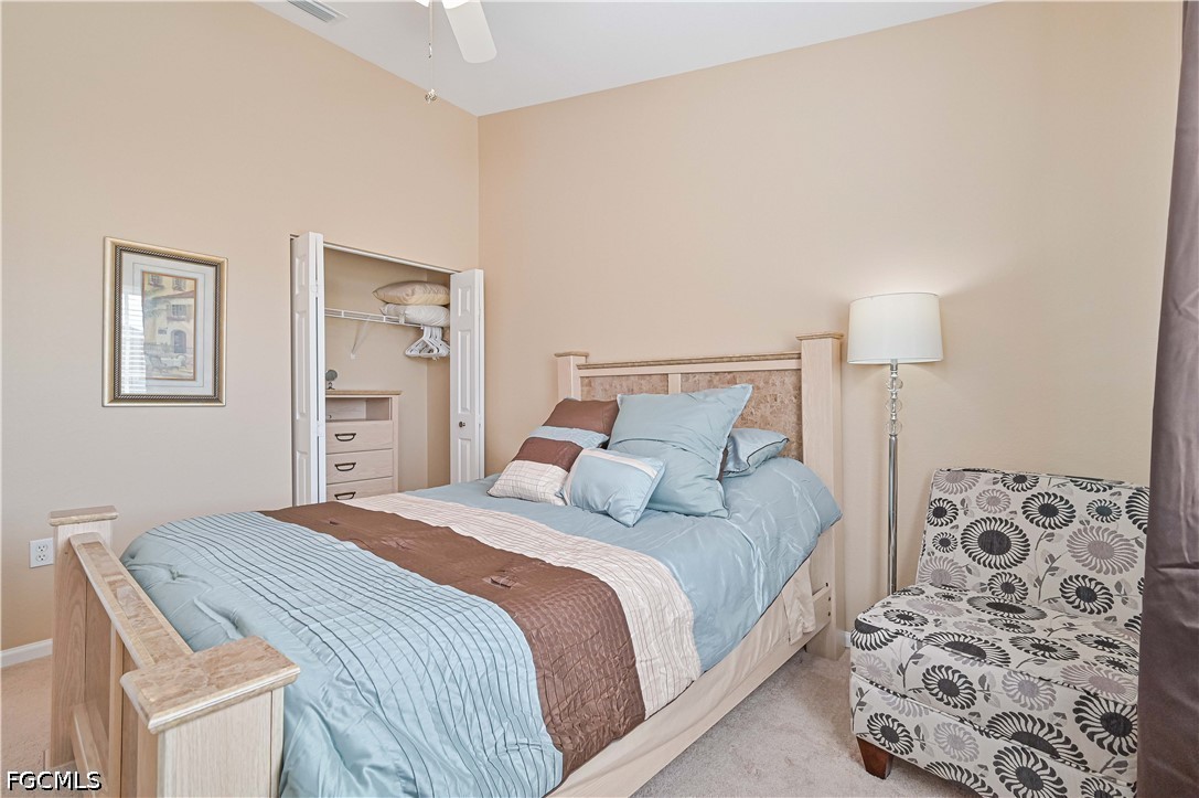 13120 Broadhurst Loop, Unit 505 Fort Myers, FL 33919 - Photo 26 of 28 a bedroom with a bed and a lamp