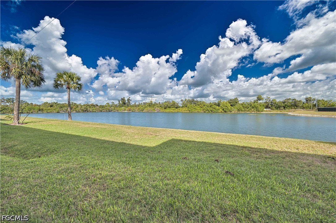 13120 Broadhurst Loop, Unit 505 Fort Myers, FL 33919 - Photo 4 of 28 a view of a lake and yard