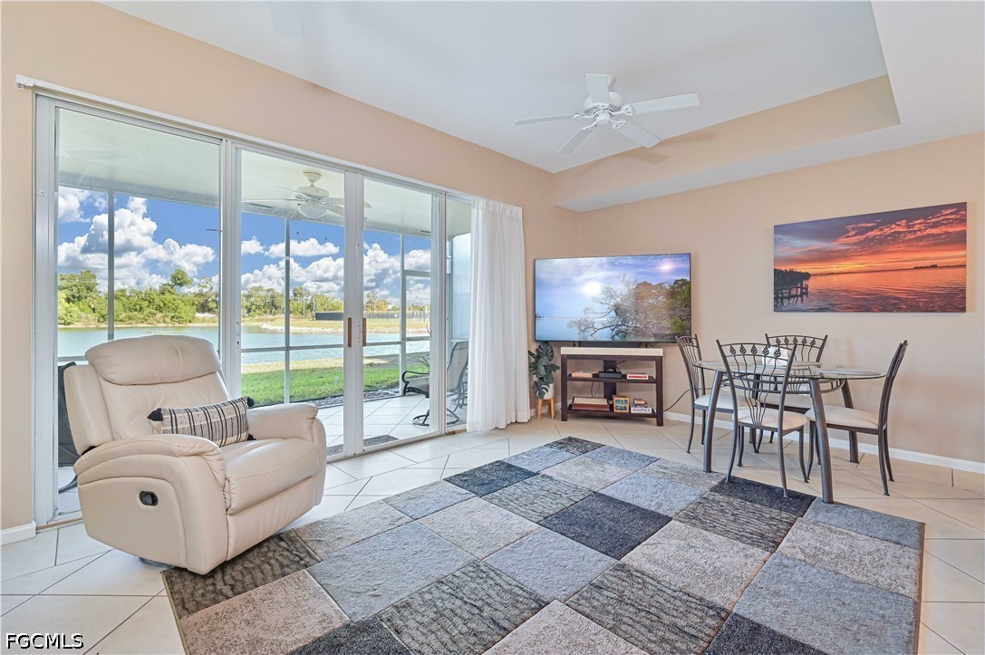 13120 Broadhurst Loop, Unit 505 Fort Myers, FL 33919 - Photo 9 of 28 a living room with furniture and a floor to ceiling window