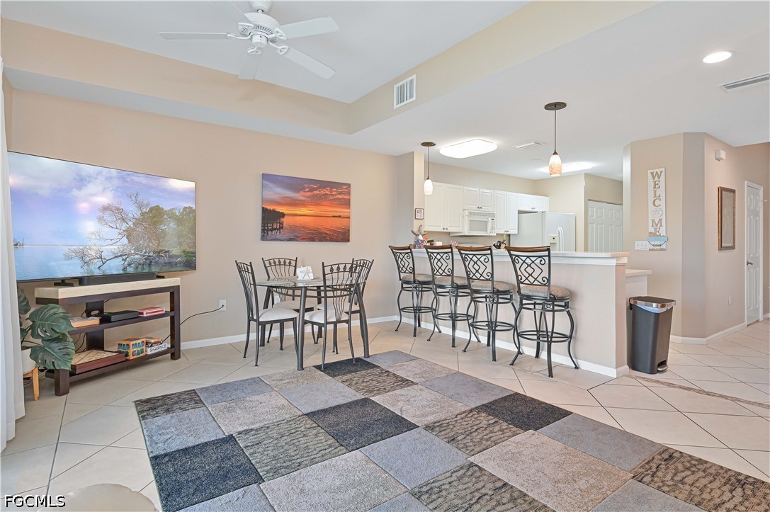13120 Broadhurst Loop, Unit 505 Fort Myers, FL 33919 - Photo 10 of 28 a open kitchen with stainless steel appliances granite countertop a stove and a dining table with chair