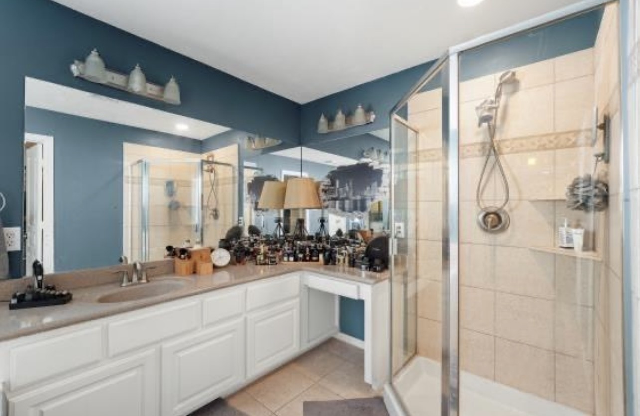 2646 Couch Street Houston, TX 77008 - Photo 12 of 21 a large bathroom with a double vanity sink a mirror a glass door and shower
