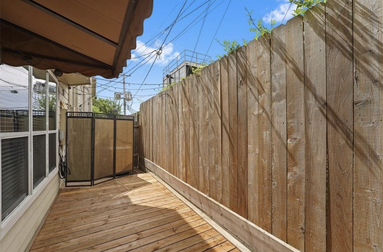 2646 Couch Street Houston, TX 77008 - Photo 21 of 21 a view of a backyard with wooden fence