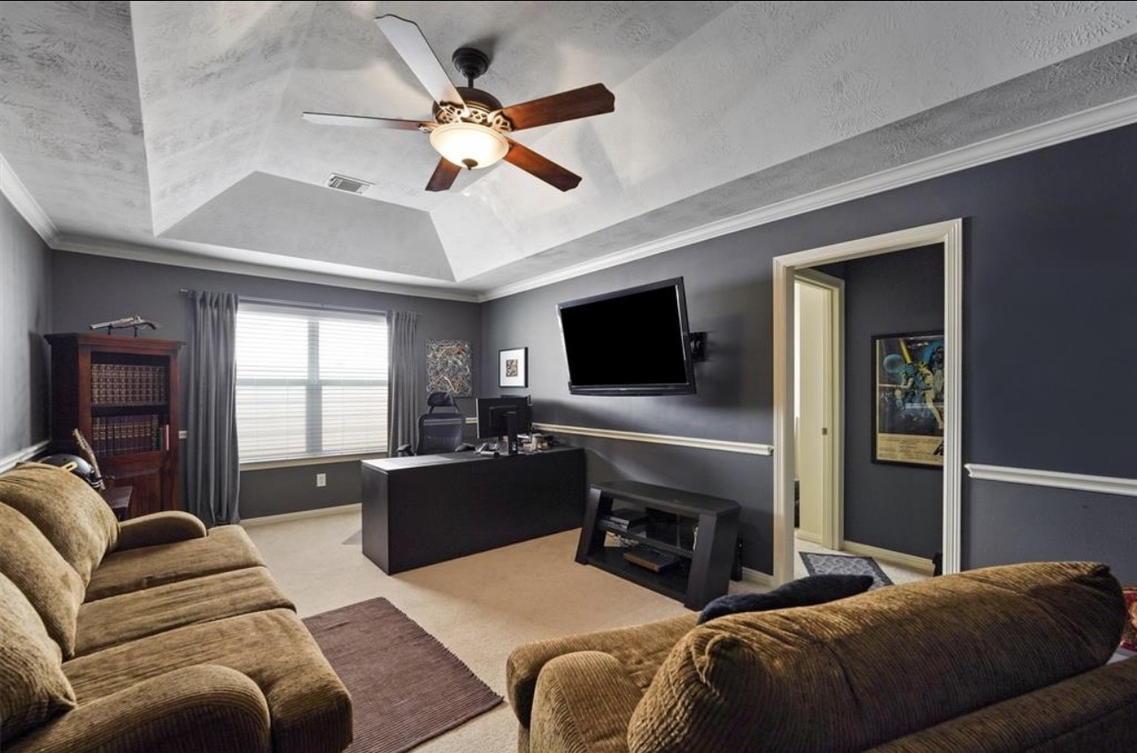 2646 Couch Street Houston, TX 77008 - Photo 8 of 21 a bedroom with furniture and a flat screen tv