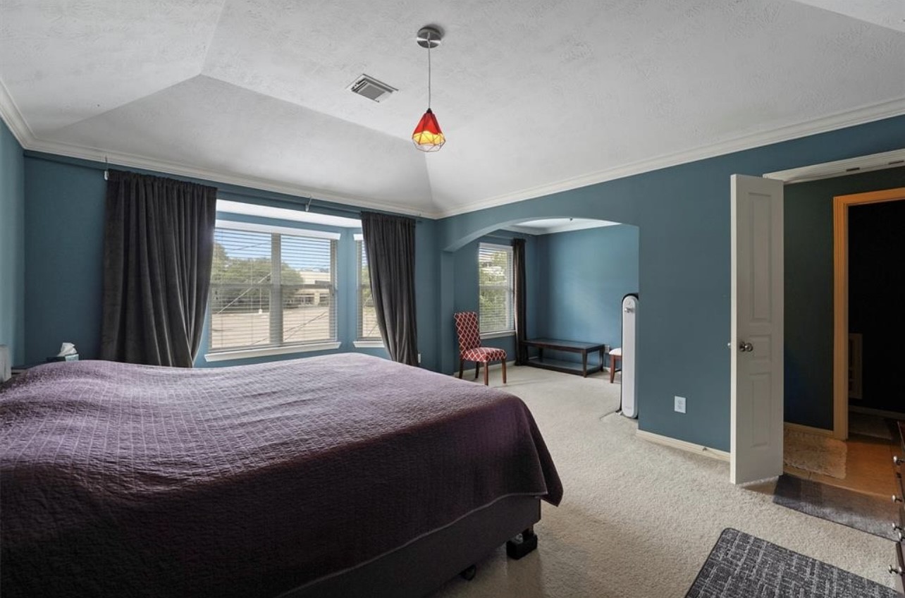 2646 Couch Street Houston, TX 77008 - Photo 10 of 21 a bedroom with a large bed and a large window