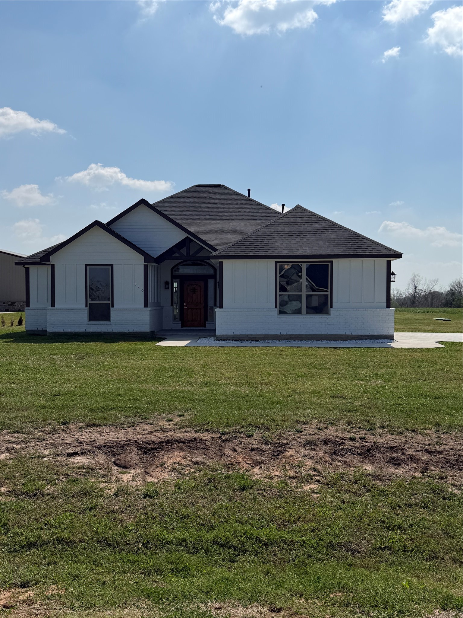 a front view of a house with a garden