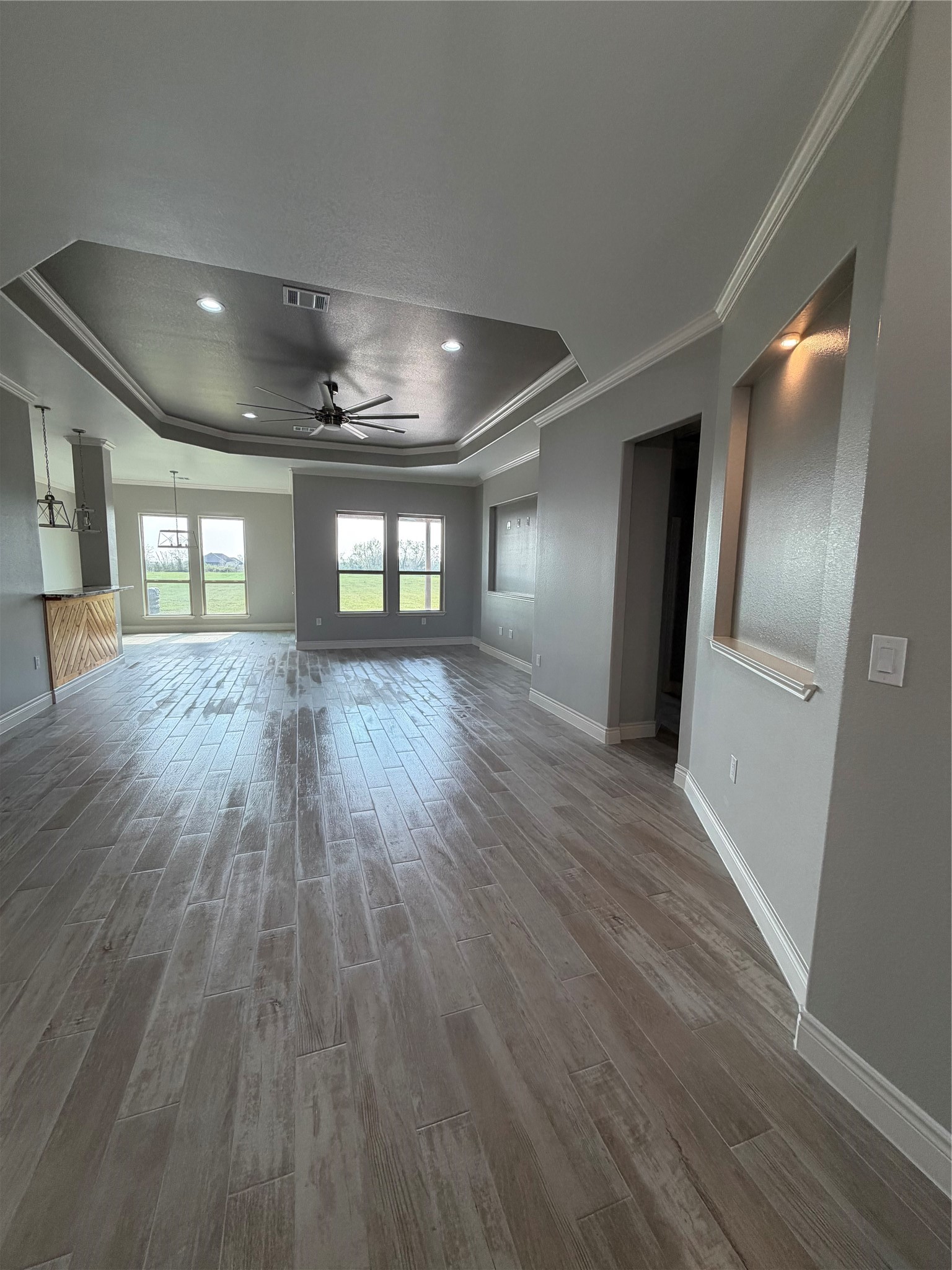 749 Buffalo Trail Angleton, TX 77515 - Photo 13 of 30 an empty room with wooden floor and windows