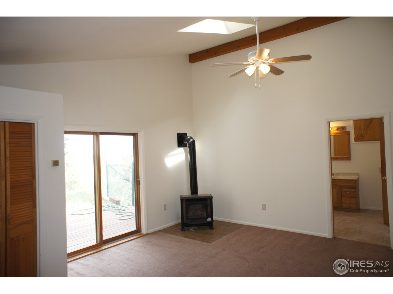 8933 Sugarloaf Road Boulder, CO 80302 - Photo 10 of 25 Master bedroom with gas fireplace