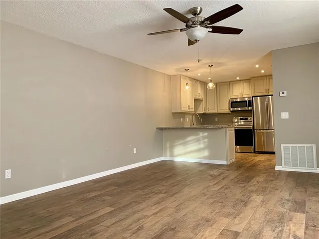 a view of kitchen with microwave and refrigerator