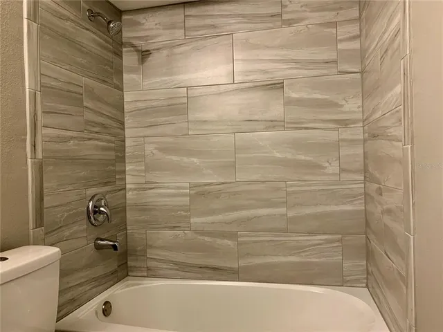 a bathroom with a shower and a toilet