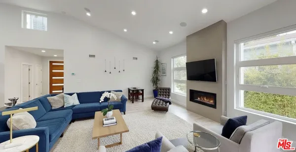 a living room with furniture flat screen tv and a fireplace
